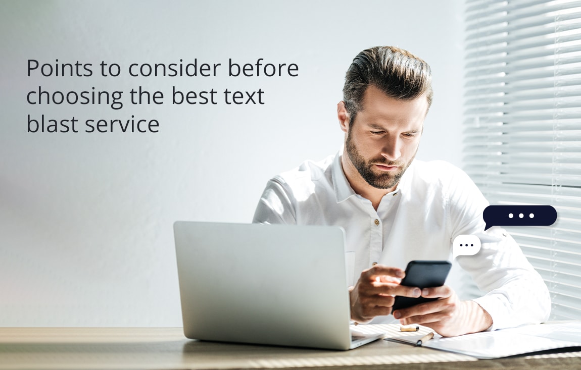 Businessman with computer and mobile choosing SMS blast service